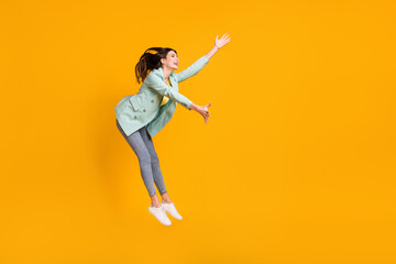 Sticker - Full length photo of pretty cute young woman wear teal blazer jumping catching empty space isolated yellow color background