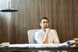 © allensima - Asian bearded designer sitting, thinking and sketching ideas indoors