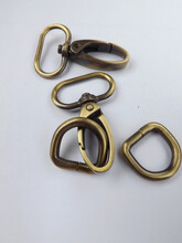 Haberdashery Accessories, Metal Snap Hooks Or Metal Swivel Clip Snap Hooks And D Rings For Bag Strap, All In Brass Color. Isolated Against White Background. 