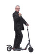 © ASDF - Side view of a man wearing suit with scooter