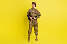 Full Length Portrait Of Charming Satisfied Girl Standing Hands Hold Tactical Belt Isolated On Yellow Color Background