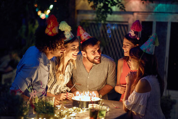 Wall Mural - A young girl, friends and birthday wishes at the open air birthday party. Quality friendship time together