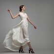 © Alena - Fashion woman portrait in white long flying airy dress