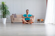 © Stavros - Photo of a middle-aged man meditating in home interior.