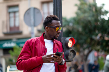 Man with mobile phone and sunglasses in the city