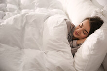 Beautiful Young Woman Wrapped With Soft Blanket Sleeping In Bed At Home