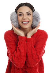 Wall Mural - Beautiful young woman wearing earmuffs on white background