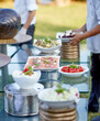 Outdoor catering banquet in summer. Table with snacks, canapes and fruits at a summer banquet