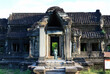 Woman walking into entrance of a temple in Angkor Wat complex, Siem Reap, Cambodia