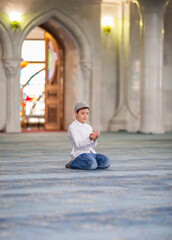 Wall Mural - little boy in the mosque read the Quran