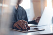 © tippapatt - Business man working on laptop computer and digital tablet in modern office