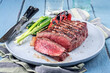 © HLPhoto - Modern style traditional barbecue dry aged angus sirloin beef steak served with vegetable as close-up on a Nordic design plate
