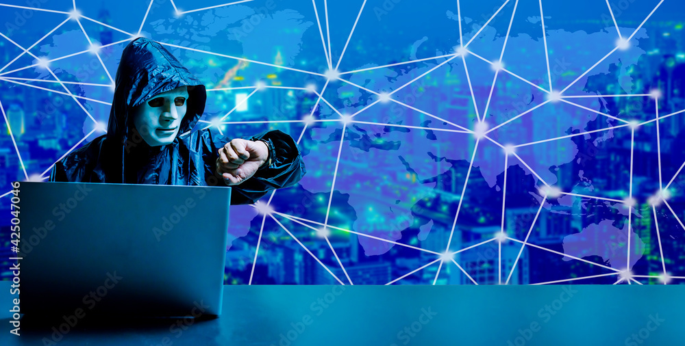Anonymous computer hacker in white mask.dark face using laptop computer ...