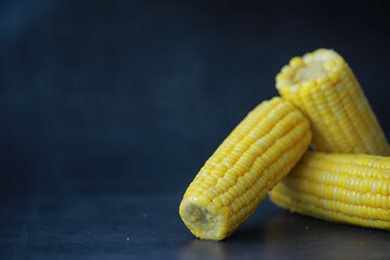 Freshly made fragrant ear of corn with salt. Farm snack of fresh corn. Healthy breakfast and healthy lifestyle concept.