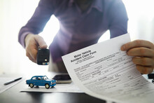 The Insurance Agent Signs A Document. Car Insurance Policy. Auto Insurance Policy. Forms For Registration Of The Contract.