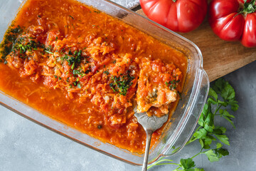 Wall Mural - Trout in tomato sauce with vegetables, garnished with parsley