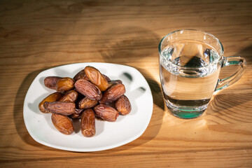 Wall Mural - Muslim iftar of breaking of fast during Ramadan month with preserved sweet dates and water