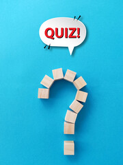 Wall Mural - quiz time concept, question mark with wooden blocks on blue background