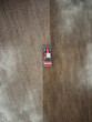 Red tractor plowing farm field aerial view looking down from above through clouds. Drone photo  cultivation machine equipment working ploughing countryside arable soil driven by farmer spring planting