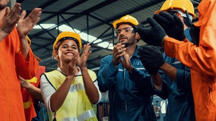 Skillful worker celebrate success in the factory . Industrial people and manufacturing labor concept .