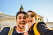 © MayR - Happy young traveler couple taking selfie with the smartphone in the famous Piazza Venezia, Roma, Italy. Concept about technology, travel, people and lifestyle.