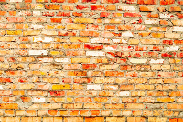 Texture of a brick wall with cracks and scratches which can be used as a background