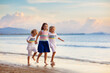 © famveldman - Kids play on tropical beach. Sand and water toy.