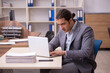 © Elnur - Young male employee working in the office
