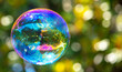 © schankz - A large soap bubble flies in the park.