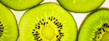 Banner Of Sliced Kiwi Slices On A White Table