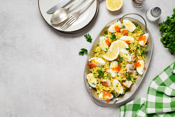 Traditional british cuisine. Fresh prepared kedgeree with smoked haddock and boiled egg. Served with fresh parsley and red caviar. top view, Space for text