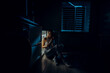 © Абай Бекенов - a hungry girl sits with her elbows on an open refrigerator holding a bottle of milk in her hands. The image was shot in a low key to convey night time.