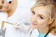 © rogerphoto - Female doctor and young woman patient in hospital. Physicians examine girl lying at the bed, view from above