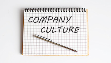 COMPANY CULTURE text on the notepad with pen