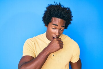 Wall Mural - Handsome african american man with afro hair wearing casual clothes feeling unwell and coughing as symptom for cold or bronchitis. health care concept.