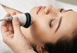 © Peakstock - Brunette woman receiving radiofrequency lifting procedure for her face skin rejuvenation at aesthetic cosmetology clinic