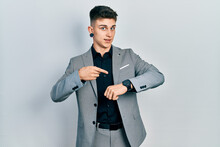 Young Caucasian Boy With Ears Dilation Wearing Business Jacket In Hurry Pointing To Watch Time, Impatience, Upset And Angry For Deadline Delay