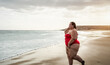 © Alessandro Biascioli - Happy plus size woman having fun walking on tropical beach during summer time - Curvy confident people lifestyle concept