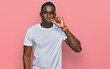 Young african american man wearing casual white t shirt mouth and lips shut as zip with fingers. secret and silent, taboo talking