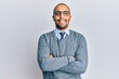 © Krakenimages.com - Hispanic adult man wearing glasses and business style happy face smiling with crossed arms looking at the camera. positive person.