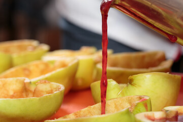 Wall Mural - Pouring berry jelly into apple molds.