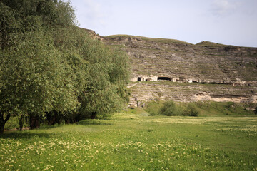 Beautiful landscape with caves in mountainside.