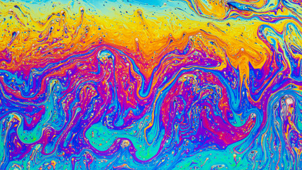 Fluid soap bubble psychedelic colorful abstract art. Surreal patterns with rainbows and waves of color in motion.