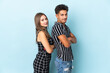 © luismolinero - Teenager caucasian couple isolated on blue background keeping the arms crossed in lateral position while smiling
