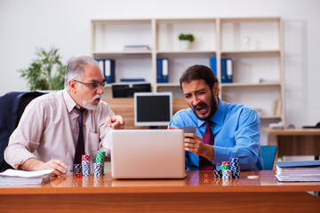 Sticker - Two male employees playing cards at workplace