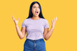 © Krakenimages.com - Young beautiful asian girl wearing casual clothes crazy and mad shouting and yelling with aggressive expression and arms raised. frustration concept.