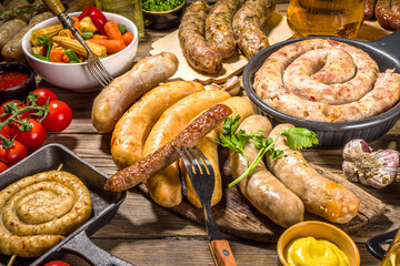 Wall Mural - Assortment of different fried sausages. Set with various meat Bavarian, Frankfurt, German grilled sausages, Oktoberfest or summer BBQ party concept, old wooden background copy space top view