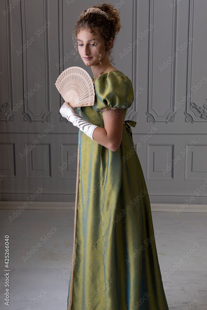 A young Regency woman wearing a green shot silk dress and satin gloves and holding a fan Stock Photo | Adobe Stock A young Regency woman wearing a green shot silk dress and satin gloves and holding a fan Stock Photo | Adobe Stock