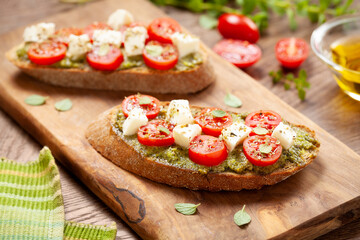 Wall Mural - Bruschetta Appetizers with cherry tomatos pesto and mozzarella