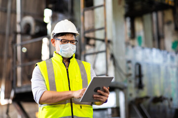 Wall Mural - Worker man wearing face mask prevent covid-19 virus and protective hard hat. Engineer Operating lathe Machinery.